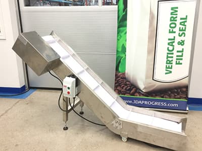 Incline finished bag pouch conveyor